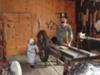 Katie operating the saw at the cabinet maker's shop